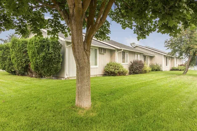 a view of a house with yard and tree s