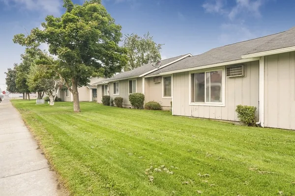 a front view of house with yard and green space