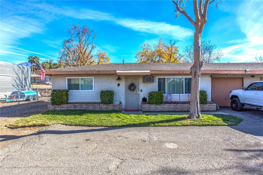 32390 Ave D Yucaipa, CA 92399 - Photo 12 of 44 a front view of a house with a yard and garage