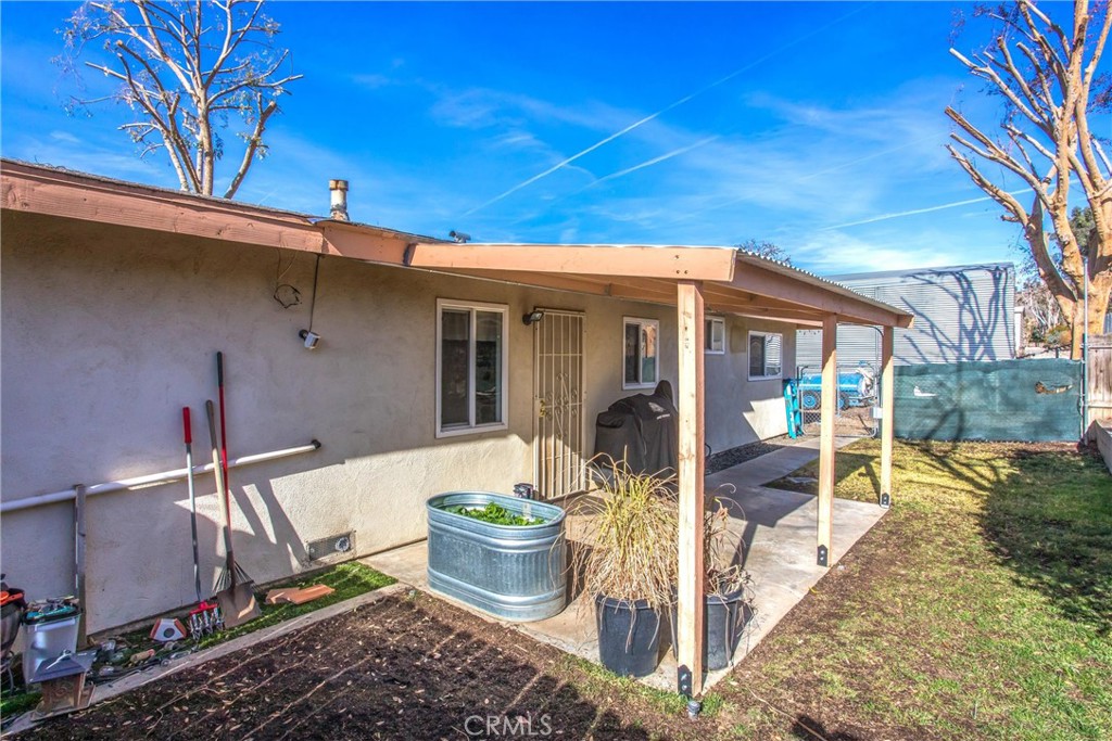 32390 Ave D Yucaipa, CA 92399 - Photo 16 of 44 a view of a patio with table and chairs and potted plants
