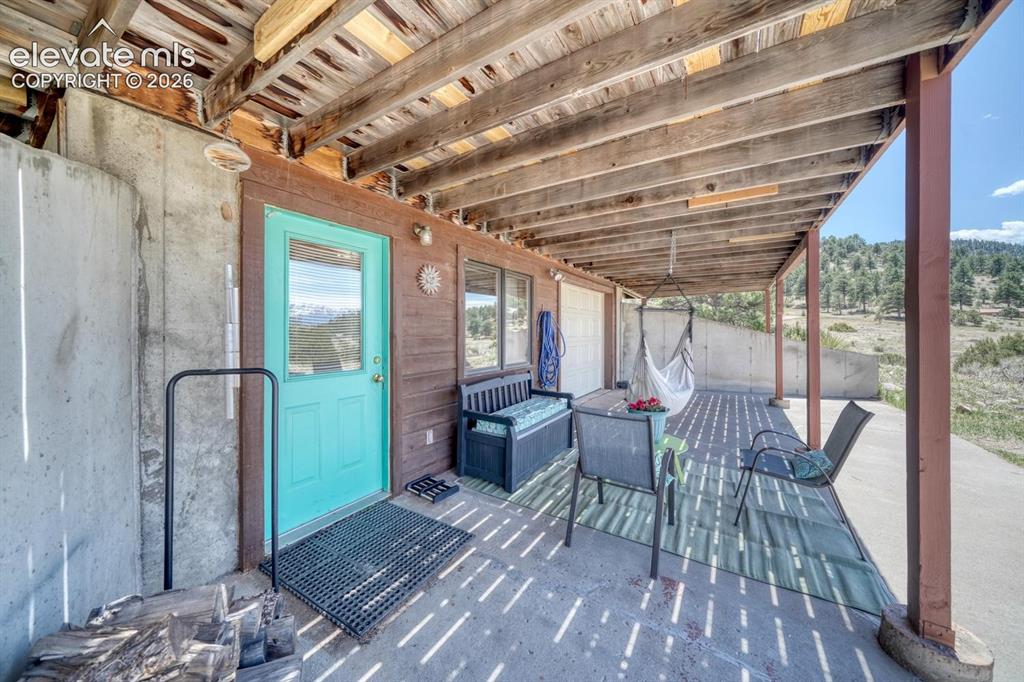 489 Excelsior Road Westcliffe, CO 81252 - Photo 27 of 34 a view of a patio with chair and tables