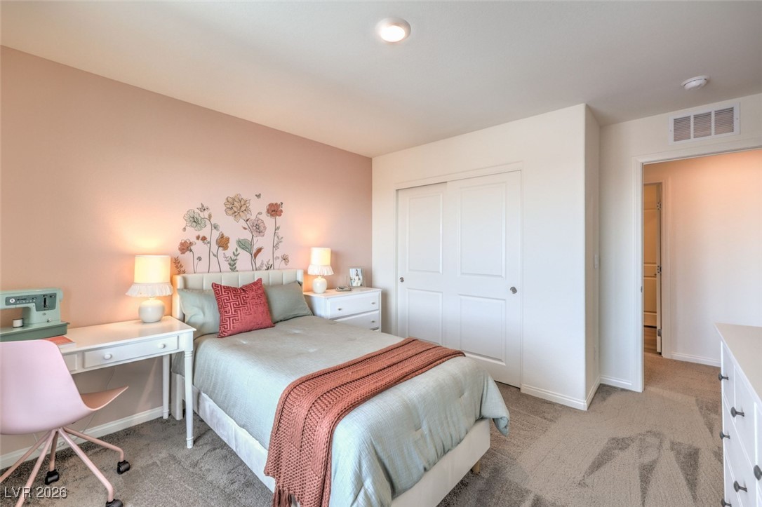 1001 Copper Robin Street, Unit 735 Henderson, NV 89011 - Photo 14 of 17 Bedroom with light colored carpet, visible vents, a closet, and baseboards.Photos are of a model home and are for representational purposes only.