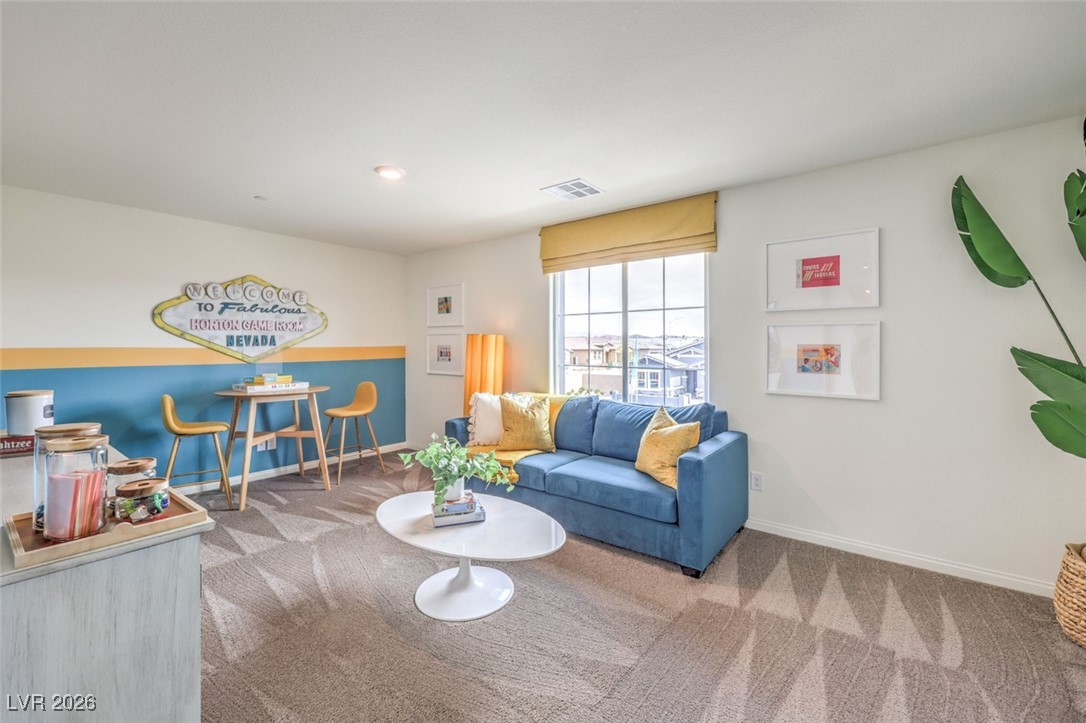 1001 Copper Robin Street, Unit 735 Henderson, NV 89011 - Photo 4 of 17 Carpeted living area with baseboards and visible .Photos are of a model home and are for representational purposes only.
