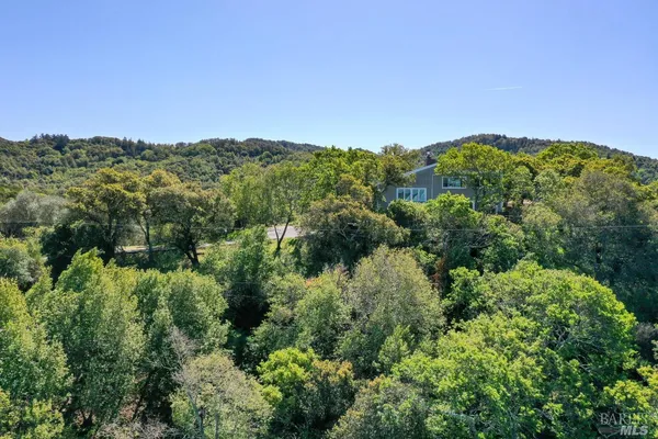 an aerial view of a houses with a yard