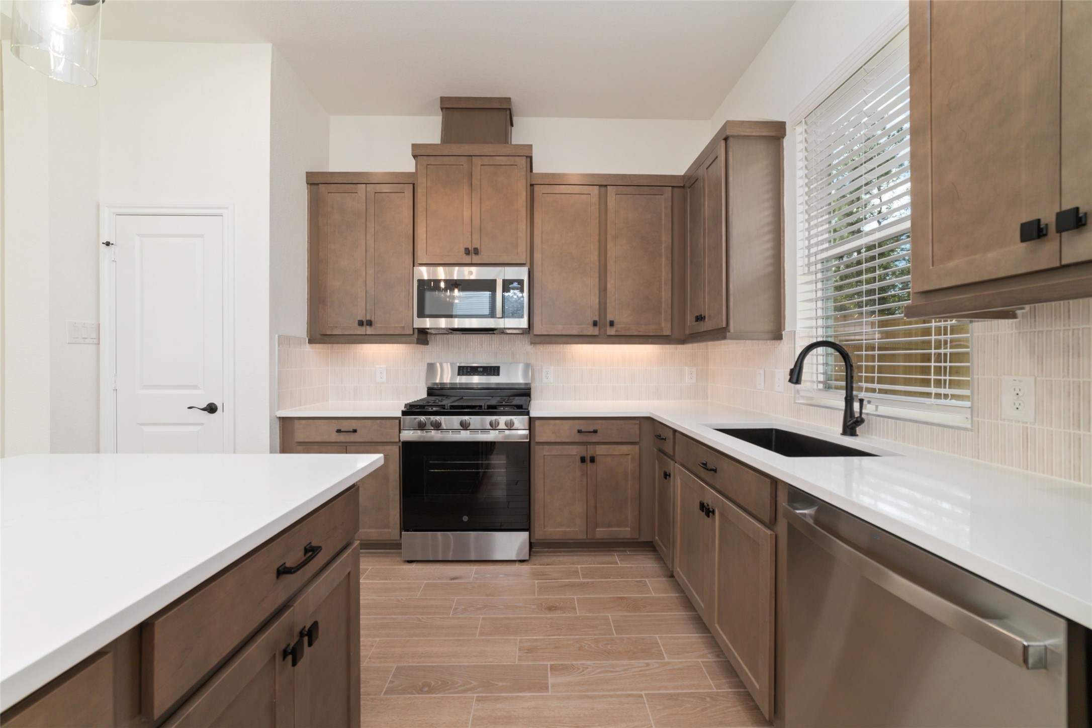 135 East Coralburst Loop, Unit 1 Montgomery, TX 77316 - Photo 11 of 22 a kitchen with stainless steel appliances granite countertop a sink stove and refrigerator