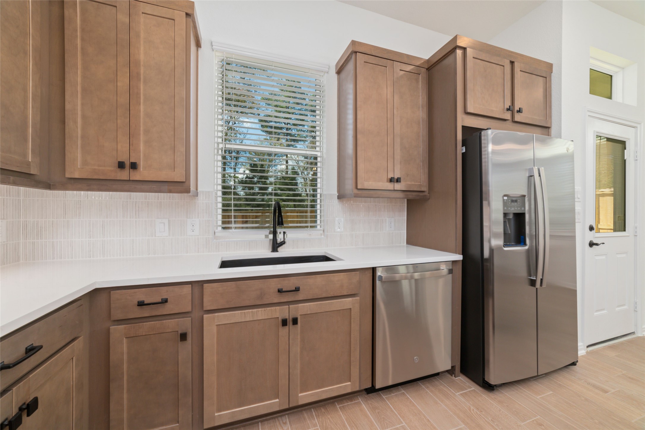 135 East Coralburst Loop, Unit 1 Montgomery, TX 77316 - Photo 12 of 22 a kitchen with stainless steel appliances white cabinets and a sink