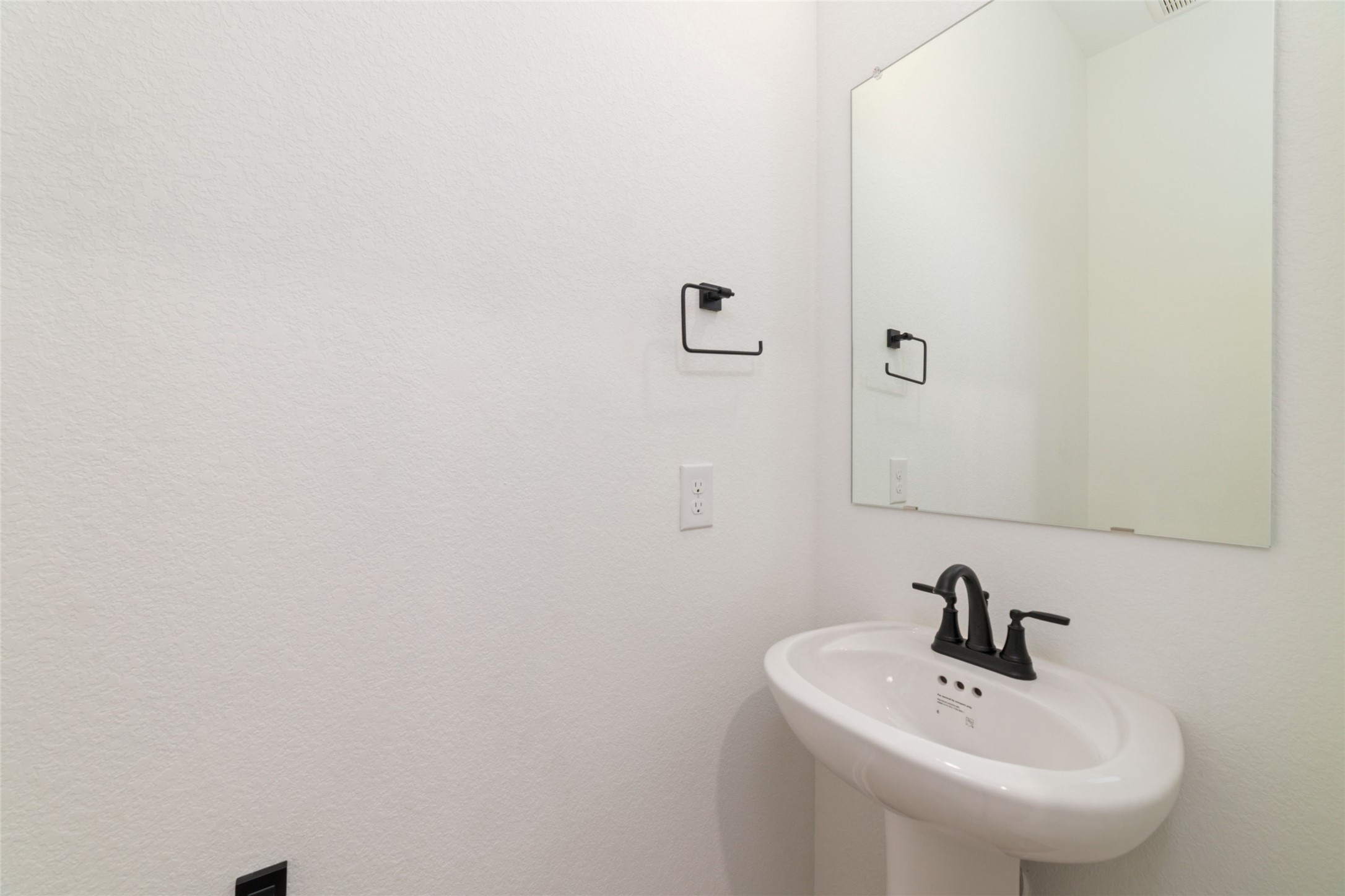 135 East Coralburst Loop, Unit 1 Montgomery, TX 77316 - Photo 13 of 22 a bathroom with a sink and a mirror