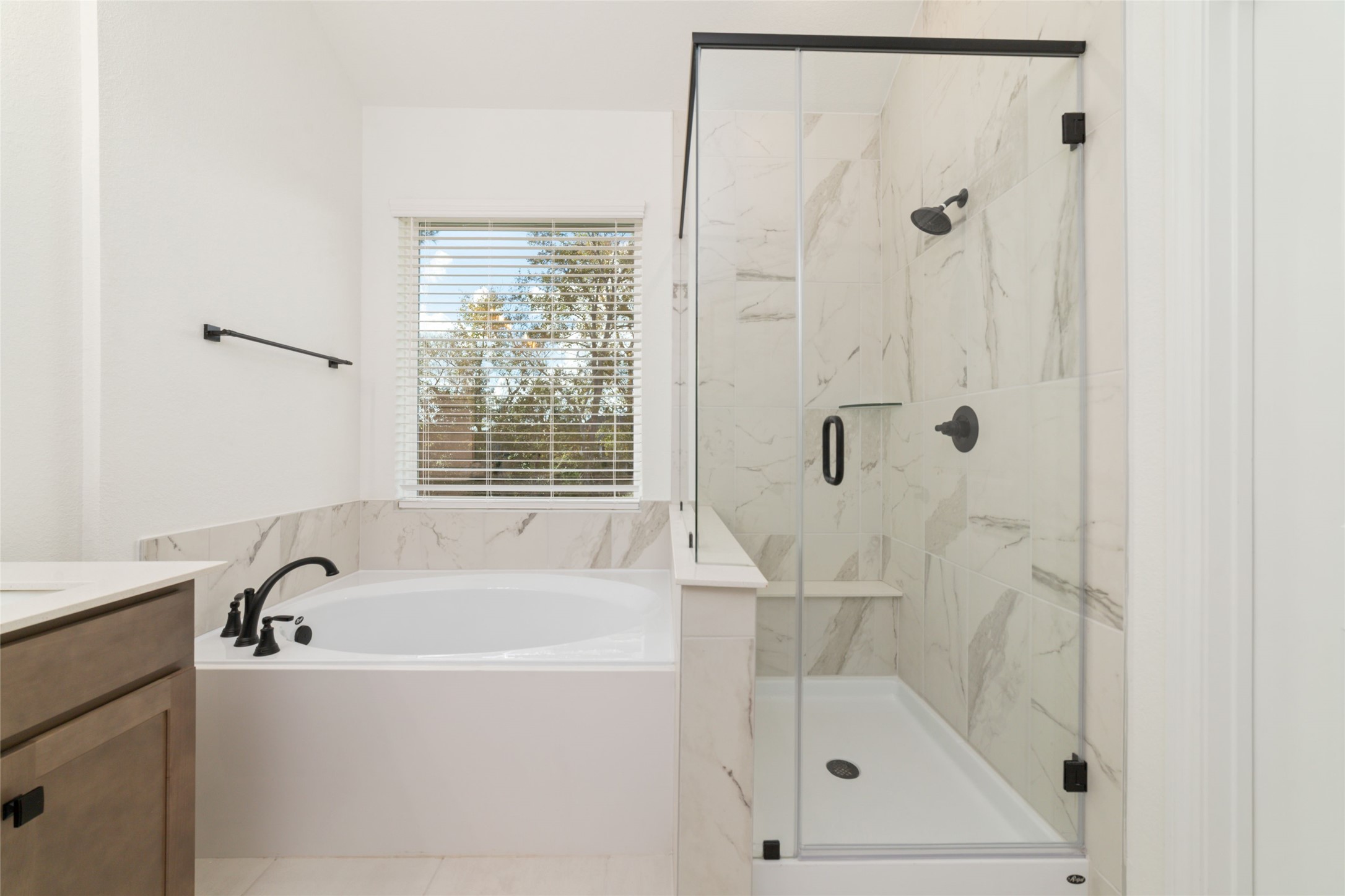 135 East Coralburst Loop, Unit 1 Montgomery, TX 77316 - Photo 17 of 22 a white bath tub sitting next to a shower