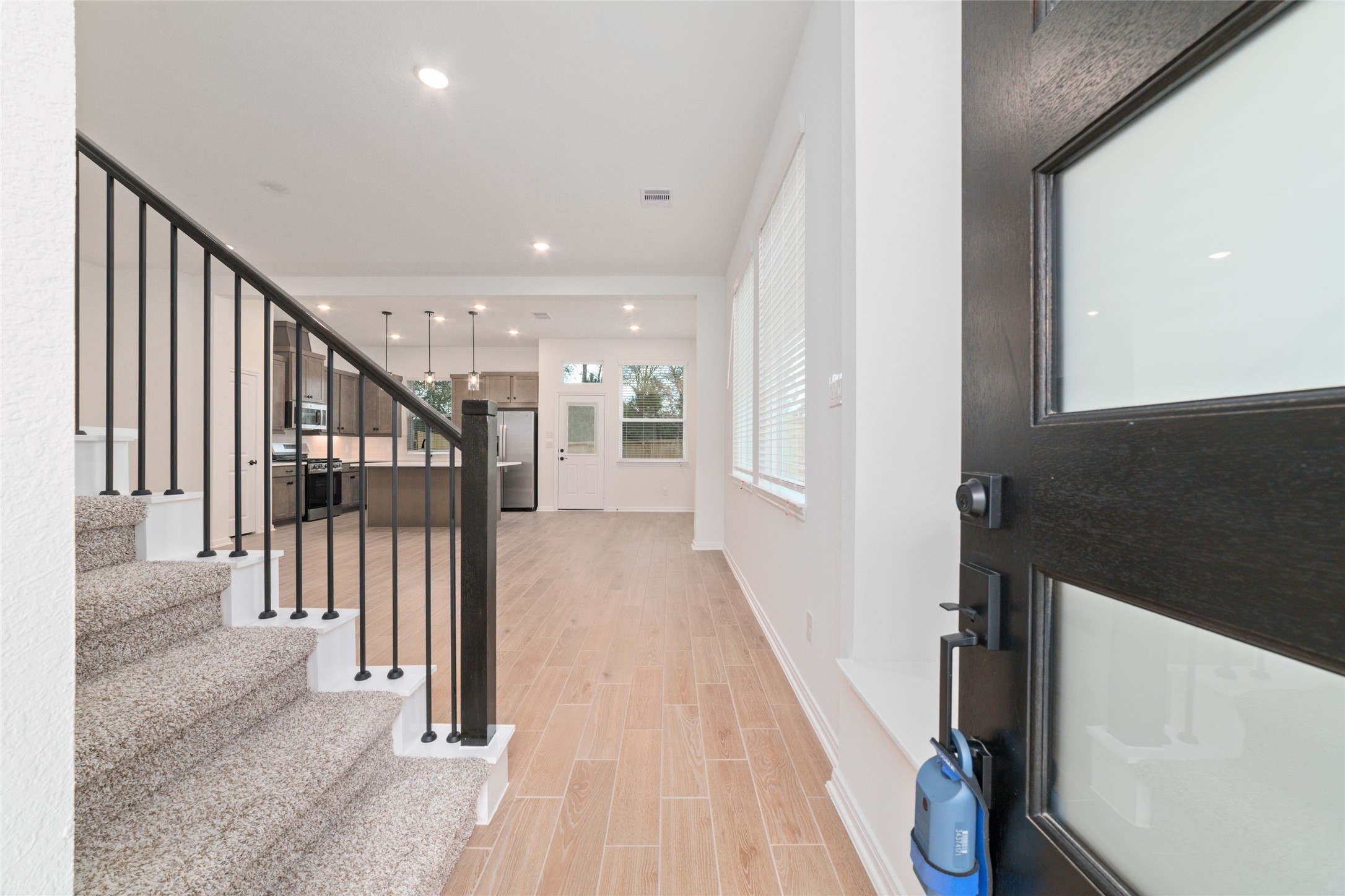 135 East Coralburst Loop, Unit 1 Montgomery, TX 77316 - Photo 4 of 22 a view of a hallway with wooden floor and staircase