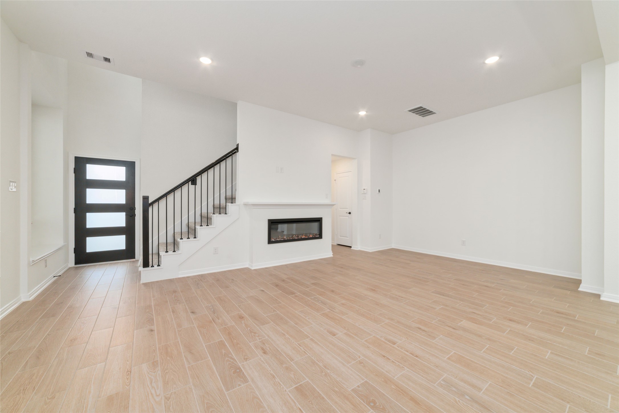 135 East Coralburst Loop, Unit 1 Montgomery, TX 77316 - Photo 6 of 22 a view of an empty room with wooden floor