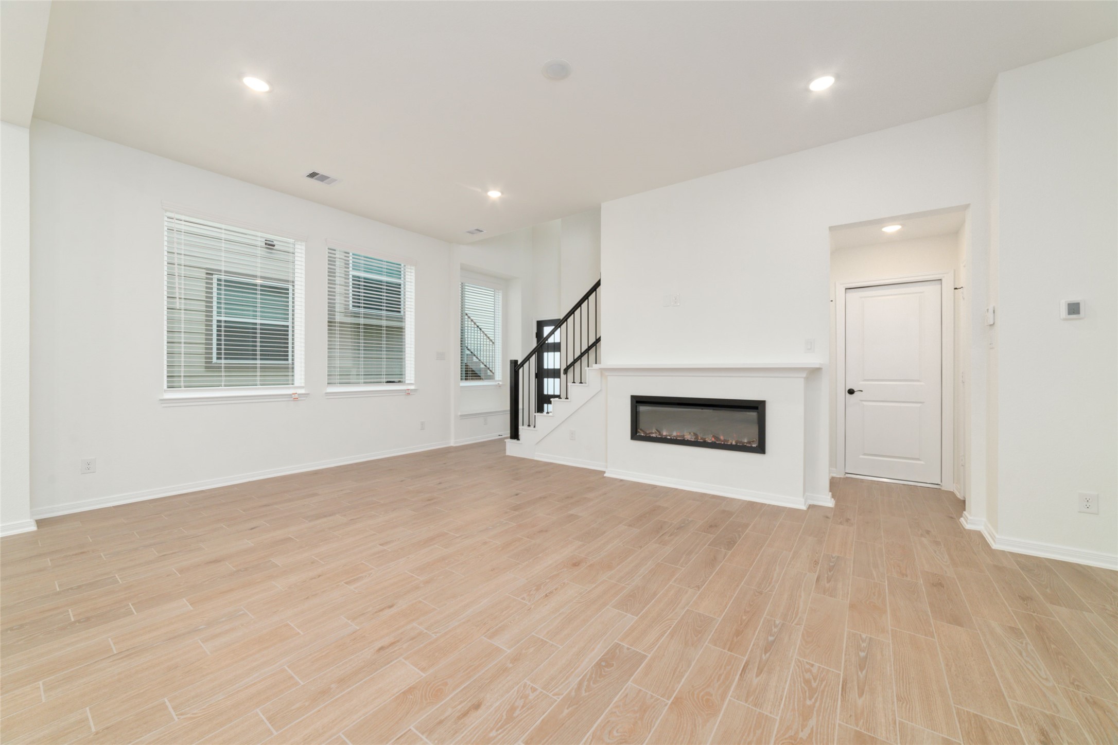 135 East Coralburst Loop, Unit 1 Montgomery, TX 77316 - Photo 7 of 22 an empty room with windows and fireplace
