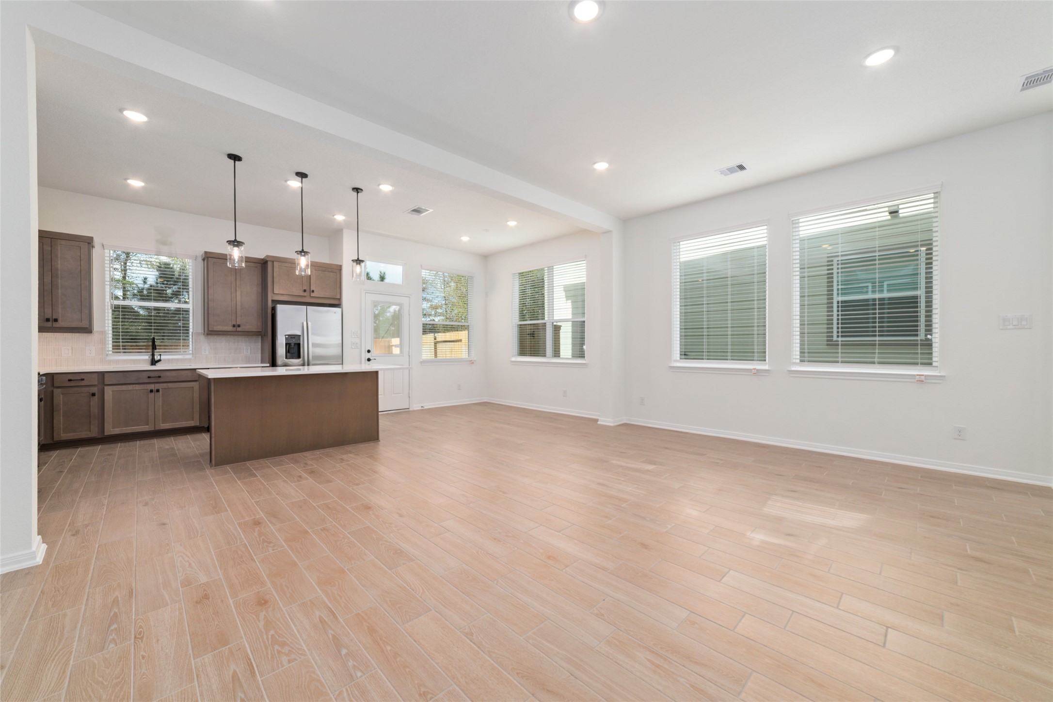 135 East Coralburst Loop, Unit 1 Montgomery, TX 77316 - Photo 8 of 22 a view of a kitchen with a refrigerator and a sink