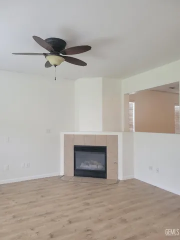 a view of an empty room with a fireplace and a window