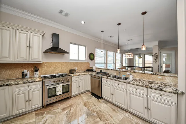 a kitchen with stainless steel appliances granite countertop a stove and a sink