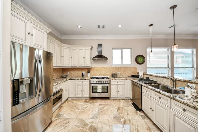 a kitchen with white cabinets and white appliances