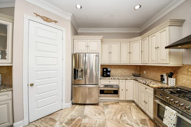 a kitchen with stainless steel appliances a refrigerator sink and stove