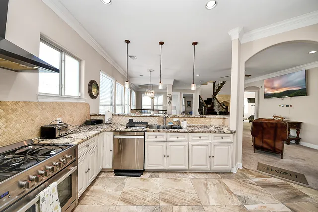 a kitchen with a stove a sink and a refrigerator