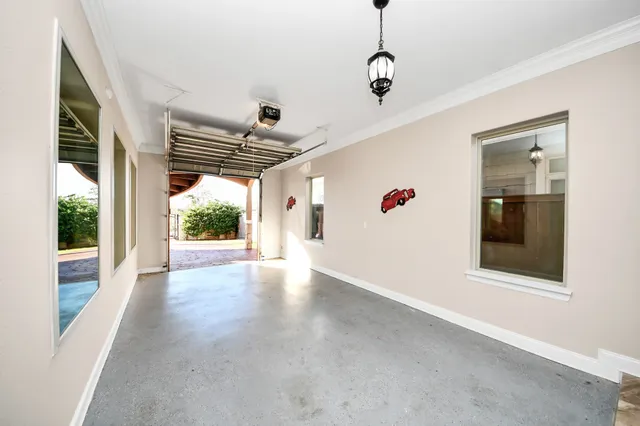 a view of a hallway to a livingroom with furniture and wooden floor