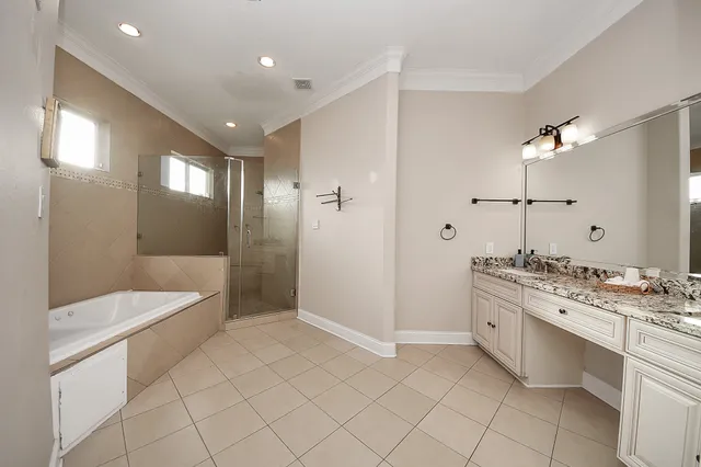 a spacious bathroom with a double vanity sink and a mirror