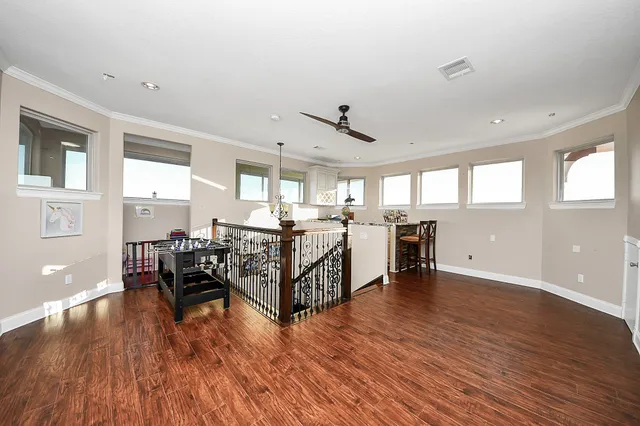 a kitchen with a wooden floor and a window