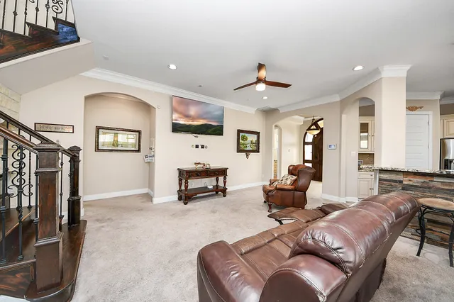 a dining room with furniture and a large window