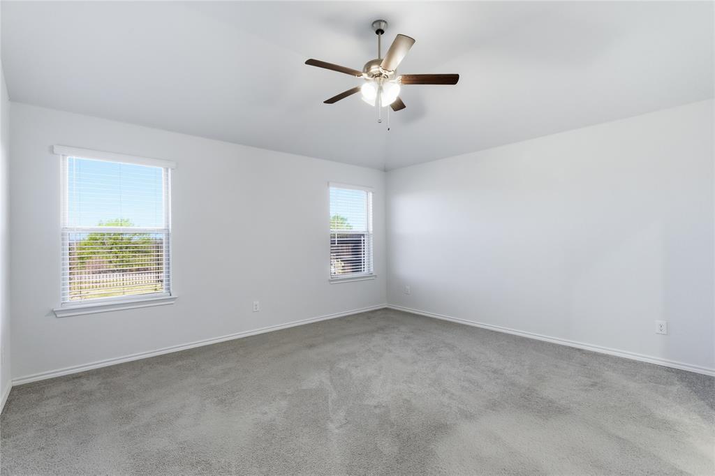 748 Ruellia Street Weatherford, TX 76086 - Photo 18 of 37 an empty room with a window and a fan