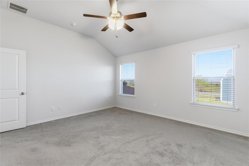 748 Ruellia Street Weatherford, TX 76086 - Photo 19 of 37 an empty room with a window and a fan