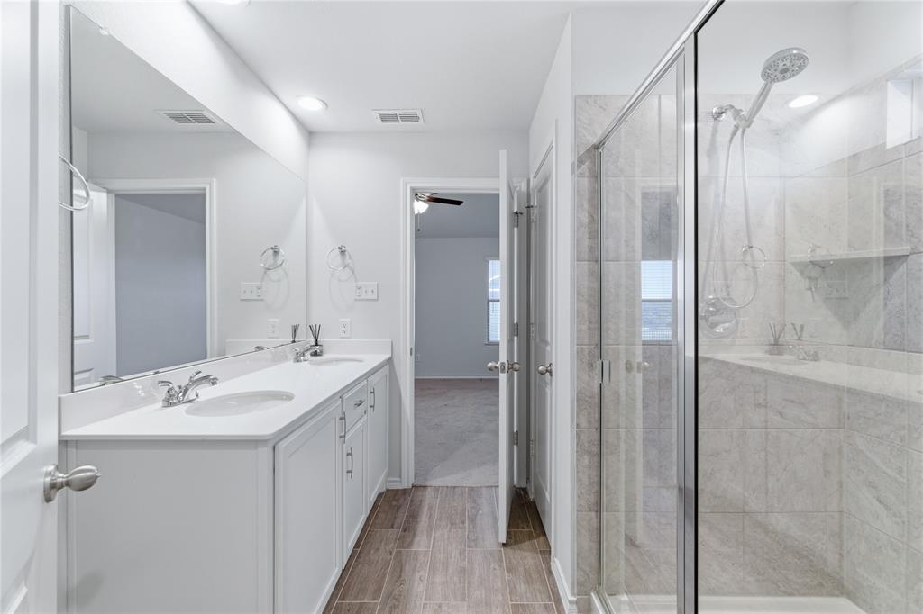 748 Ruellia Street Weatherford, TX 76086 - Photo 20 of 37 a bathroom with a double vanity sink mirror and shower