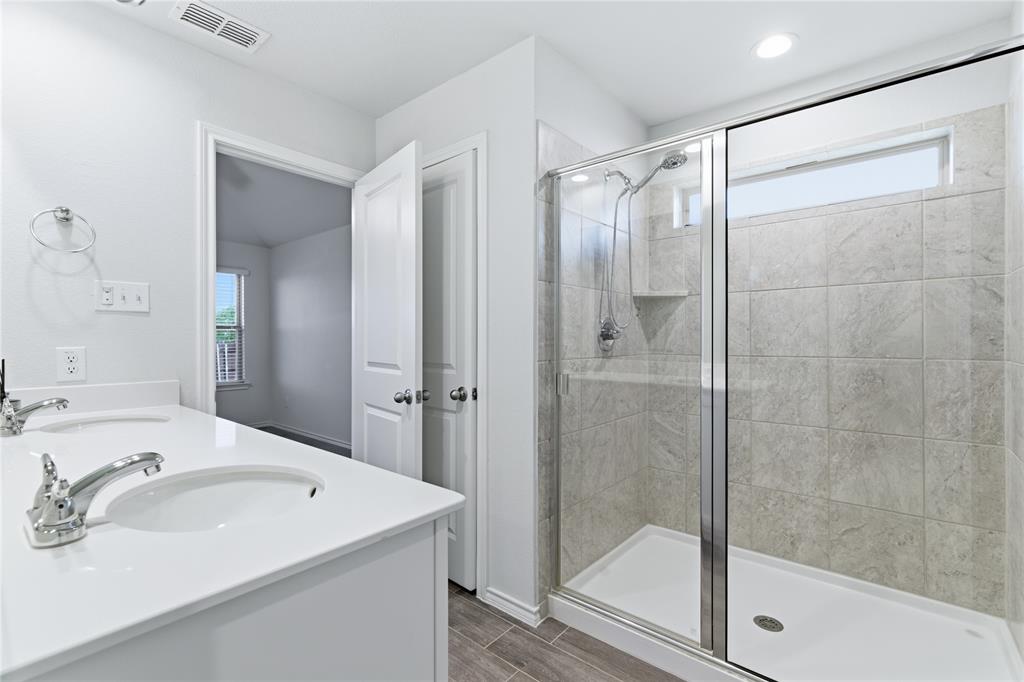 748 Ruellia Street Weatherford, TX 76086 - Photo 22 of 37 a bathroom with a shower sink and mirror