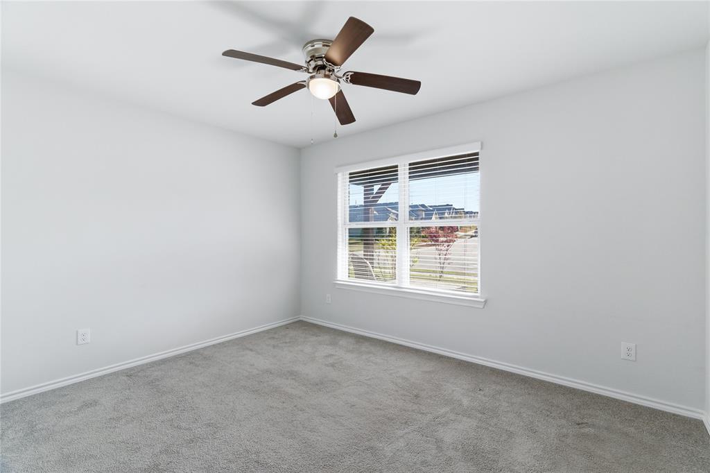 748 Ruellia Street Weatherford, TX 76086 - Photo 24 of 37 an empty room with a window and a fan