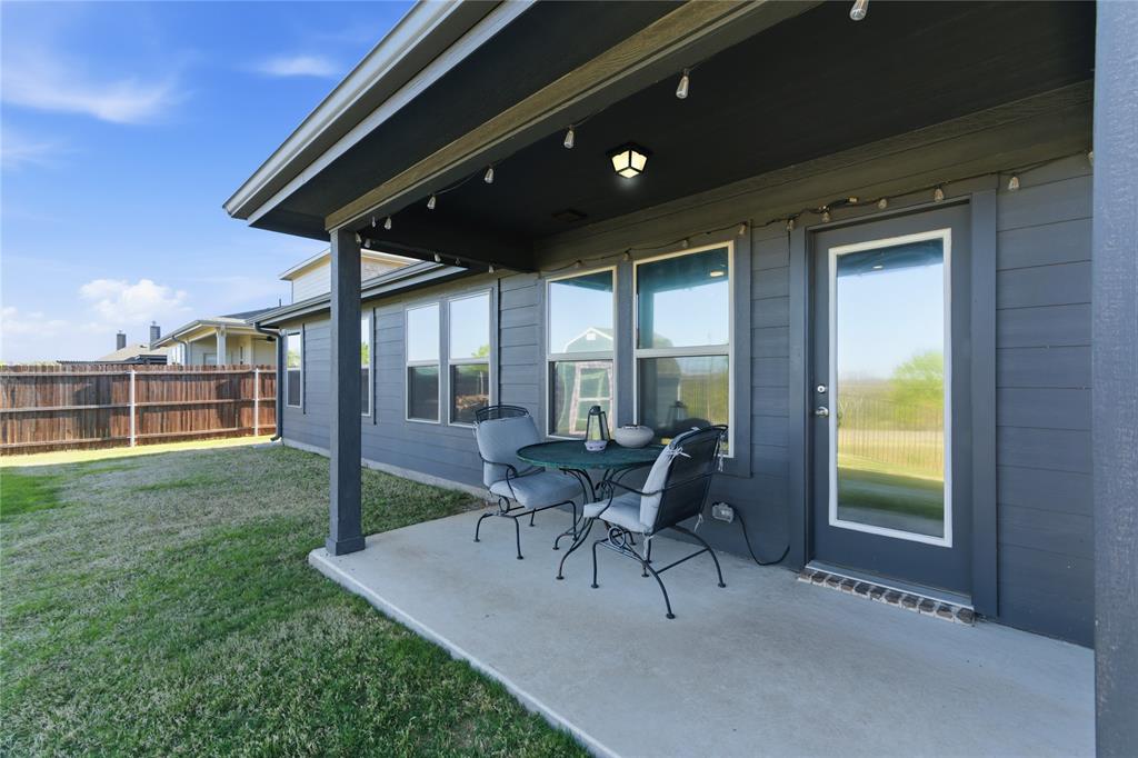 748 Ruellia Street Weatherford, TX 76086 - Photo 29 of 37 a patio with yard glass top table and chairs