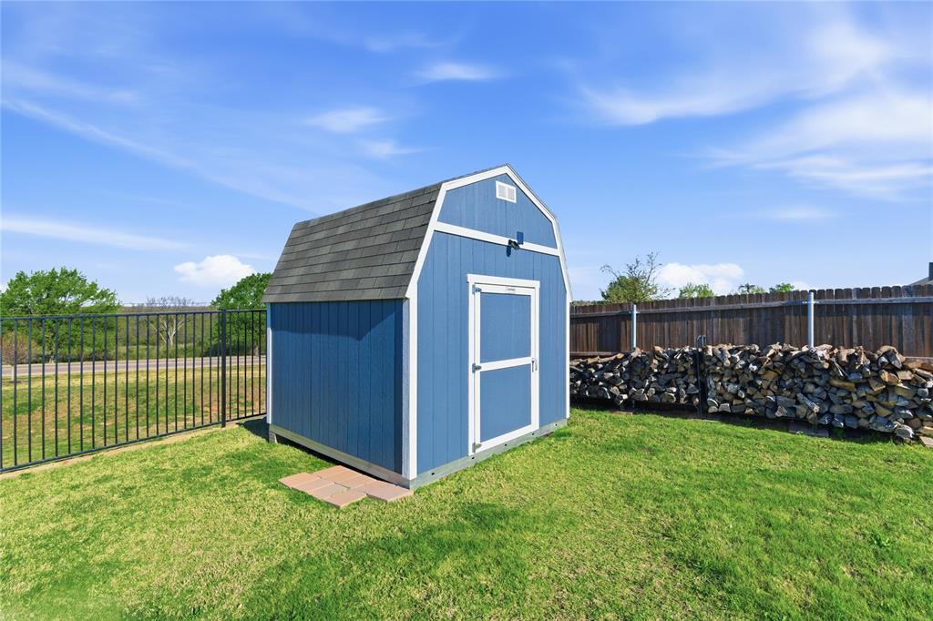 748 Ruellia Street Weatherford, TX 76086 - Photo 32 of 37 a view of a backyard with a garden