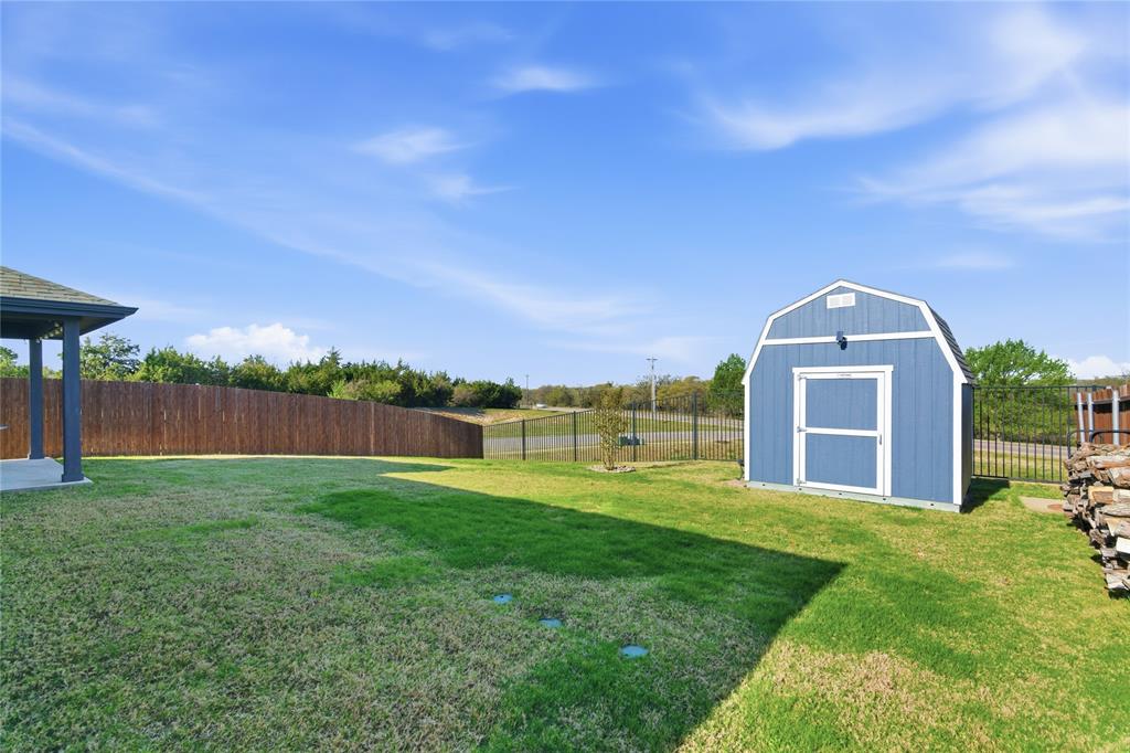 748 Ruellia Street Weatherford, TX 76086 - Photo 33 of 37 a view of a big house with a big yard and large trees