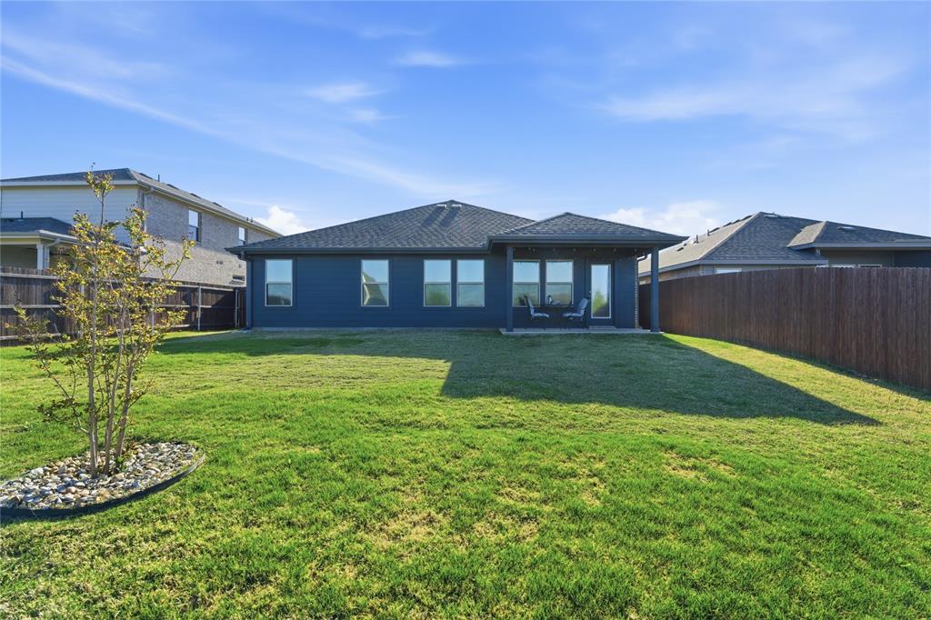 748 Ruellia Street Weatherford, TX 76086 - Photo 4 of 37 a front view of a house with a yard