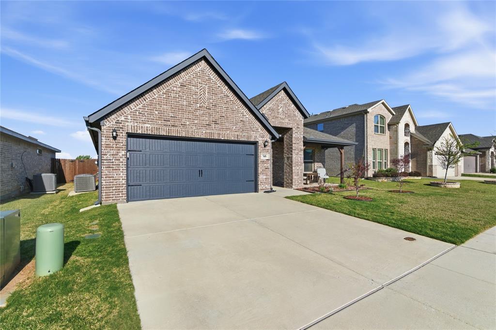 748 Ruellia Street Weatherford, TX 76086 - Photo 6 of 37 a front view of a house with a yard and garage