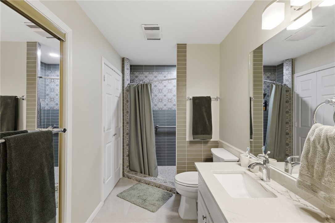 1520 Bennett Street Bryan, TX 77802 - Photo 16 of 24 a bathroom with a sink toilet and shower