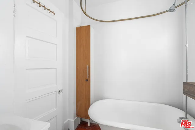 a bathroom with a white bath tub and shower