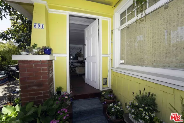 a view of front door and potted plants