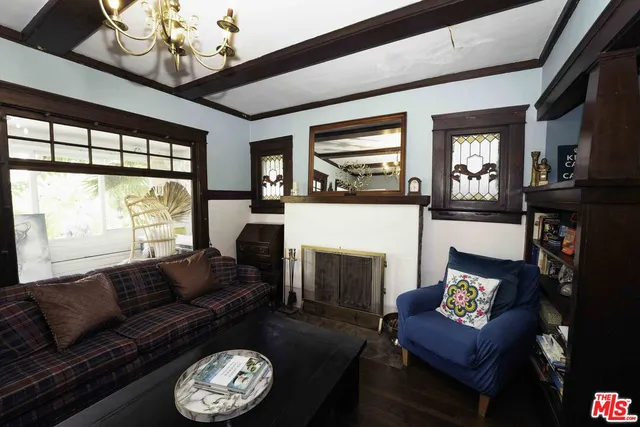 a living room with furniture a fireplace and a large window