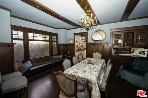 a living room with furniture a flat screen tv and a table