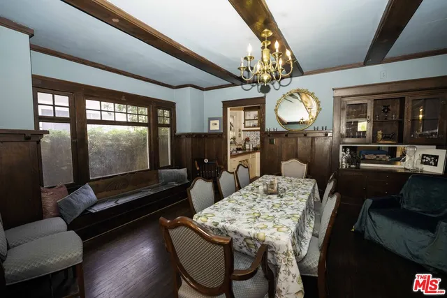 a living room with furniture a flat screen tv and a table