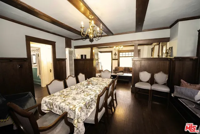 a living room with furniture a rug and a floor to ceiling window