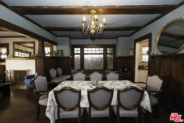 a view of a dining room with furniture wooden floor and chandelier