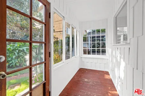 a view of a porch with a floor to ceiling window