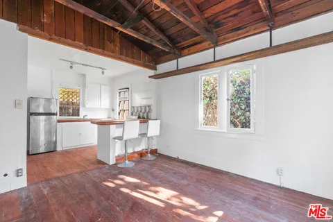 a view of kitchen with furniture and refrigerator