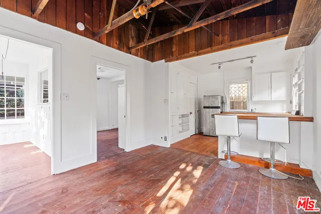 a large white kitchen with white cabinets and a sink