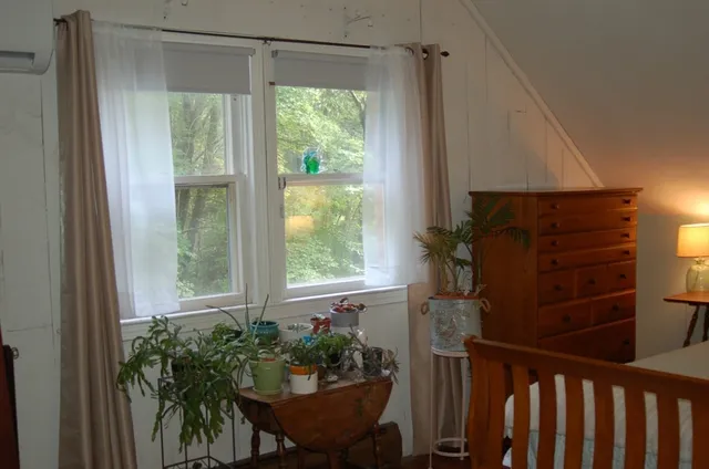 a living room with furniture and a mirror