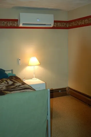 a bedroom with a bed and a table