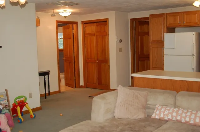 a bed sitting in a room next to a blue wall