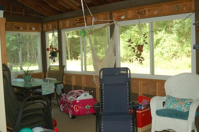 a living room filled with furniture and a potted plant